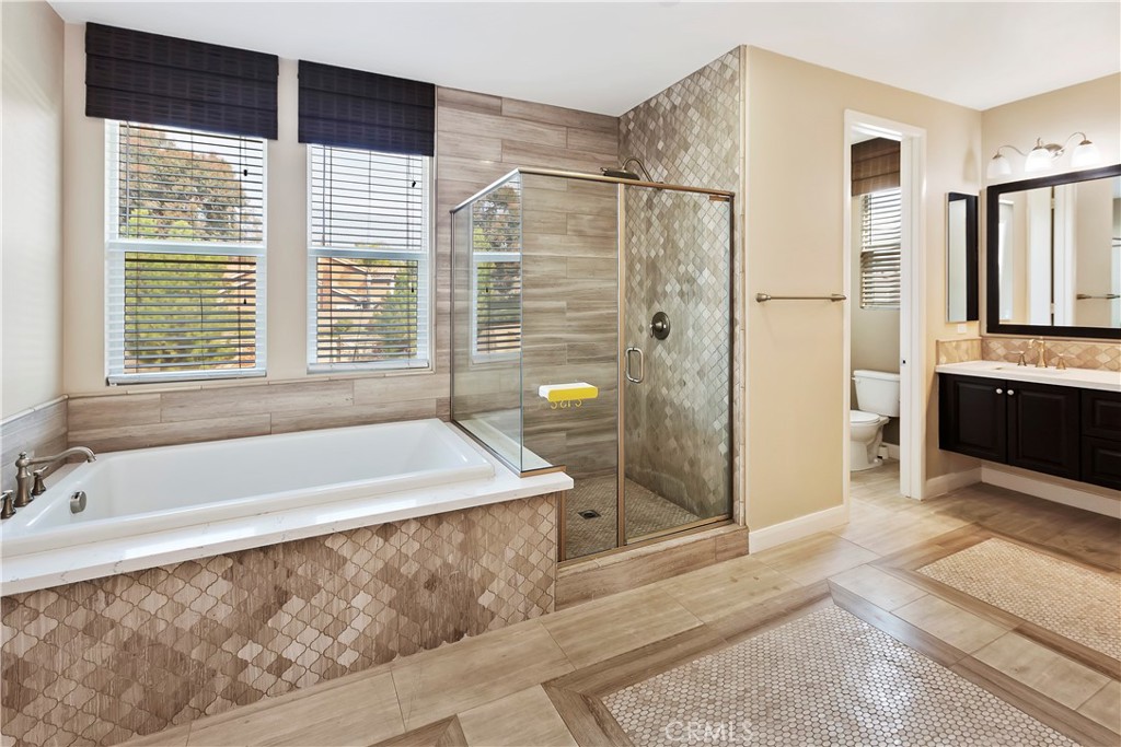 11558 Grimaldi Road Rancho Cucamonga, CA 91701 - Photo 35 of 45 a spacious bathroom with a tub shower and windows