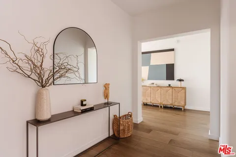 a room with a wooden floor and a table with wooden floor