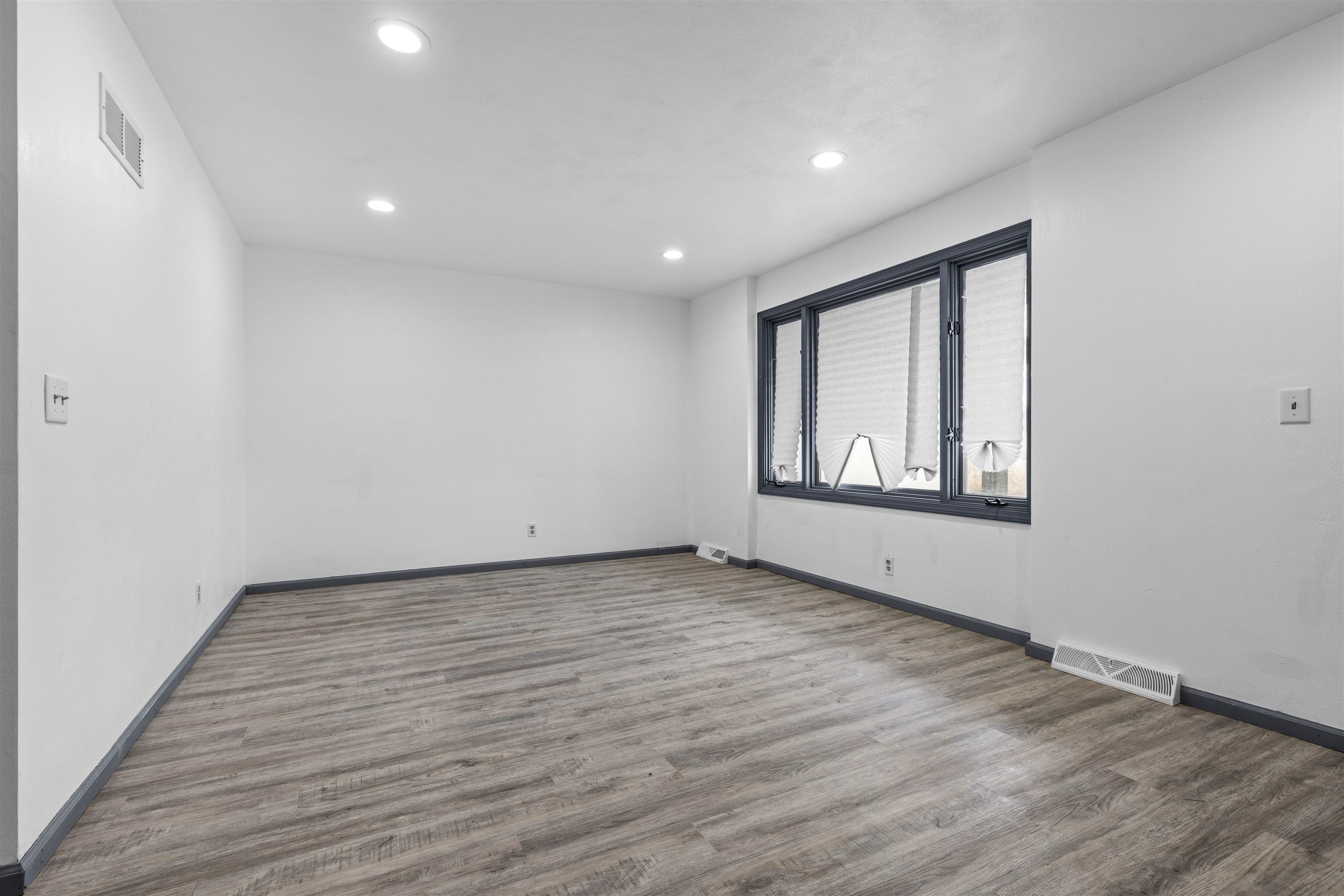 7010 Prairie Hill Road South Beloit, IL 61080 - Photo 4 of 21 a view of an empty room with wooden floor and a window