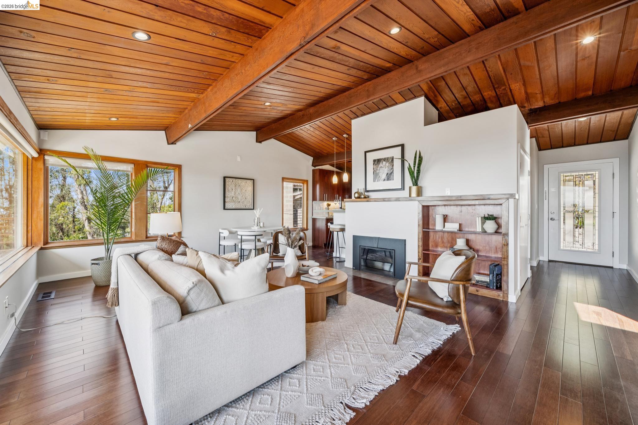 1394 Queens Road Berkeley, CA 94708 - Photo 4 of 63 Vaulted wood-paneled ceiling with exposed beams, recessed lighting, expansive windows, wood-finish flooring, and built-in shelving