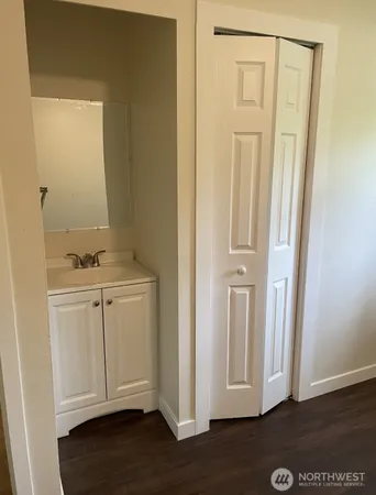 a view of storage and utility room with wooden floor