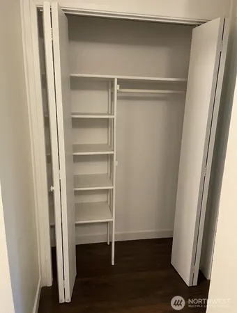 a view of walk in closet with empty racks
