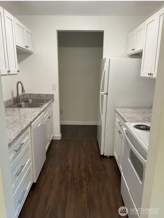 a kitchen with a sink stove and refrigerator