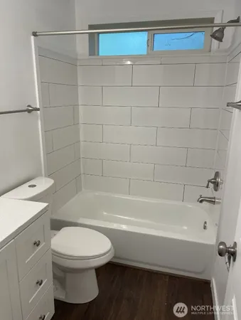a bathroom with a toilet a sink and bathtub