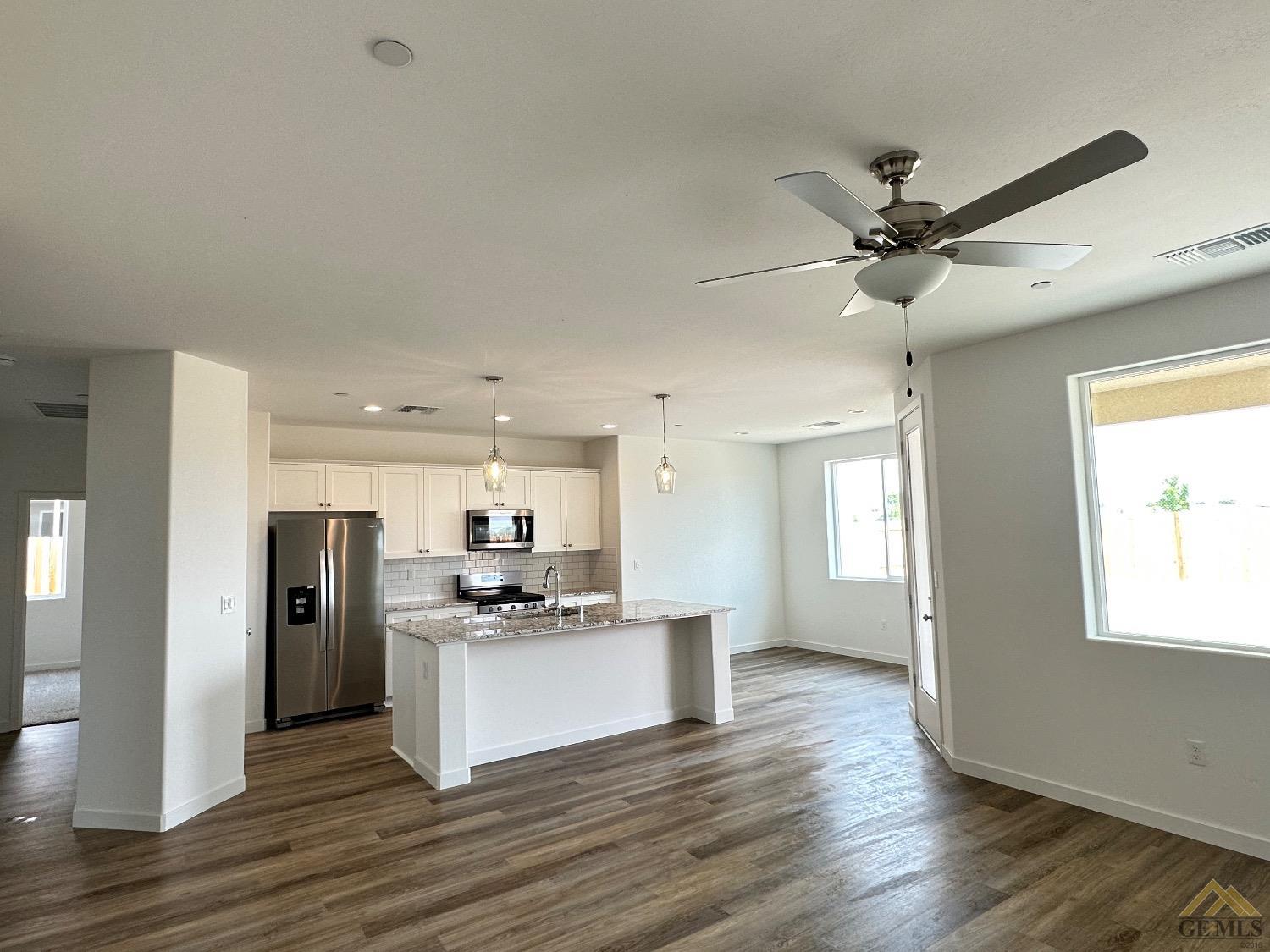 Undisclosed Address Bakersfield, CA 93311 - Photo 13 of 13 a view of kitchen with stainless steel appliances refrigerator stove microwave and cabinets
