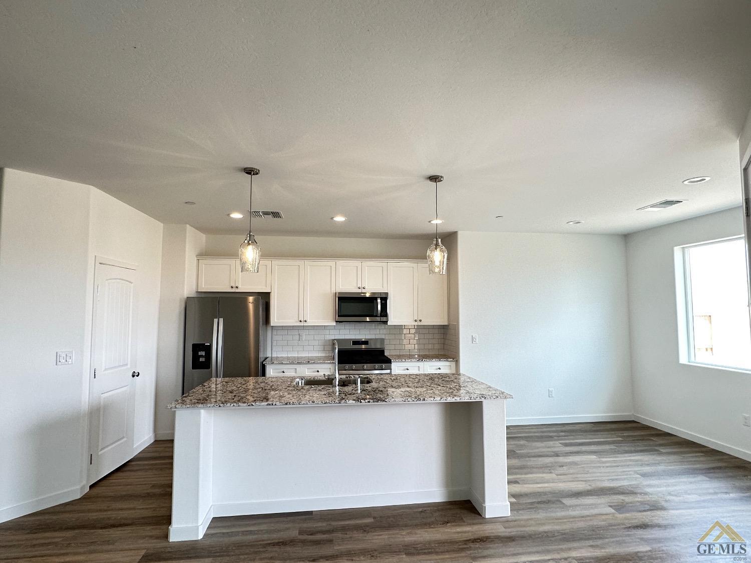 Undisclosed Address Bakersfield, CA 93311 - Photo 2 of 13 a view of kitchen with stainless steel appliances granite countertop refrigerator stove microwave and oven