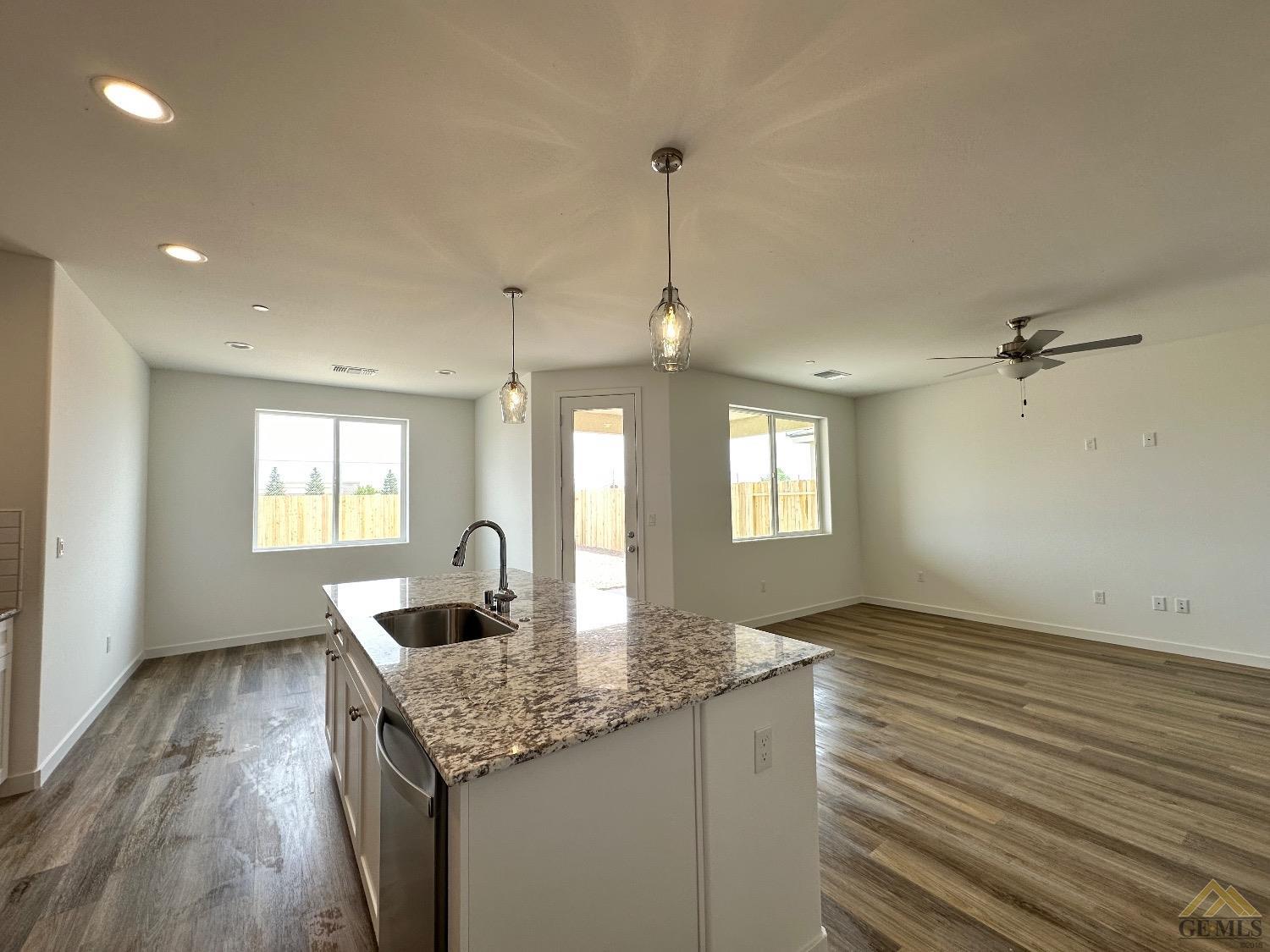 Undisclosed Address Bakersfield, CA 93311 - Photo 4 of 13 a kitchen with granite countertop kitchen island a sink appliances and a counter space