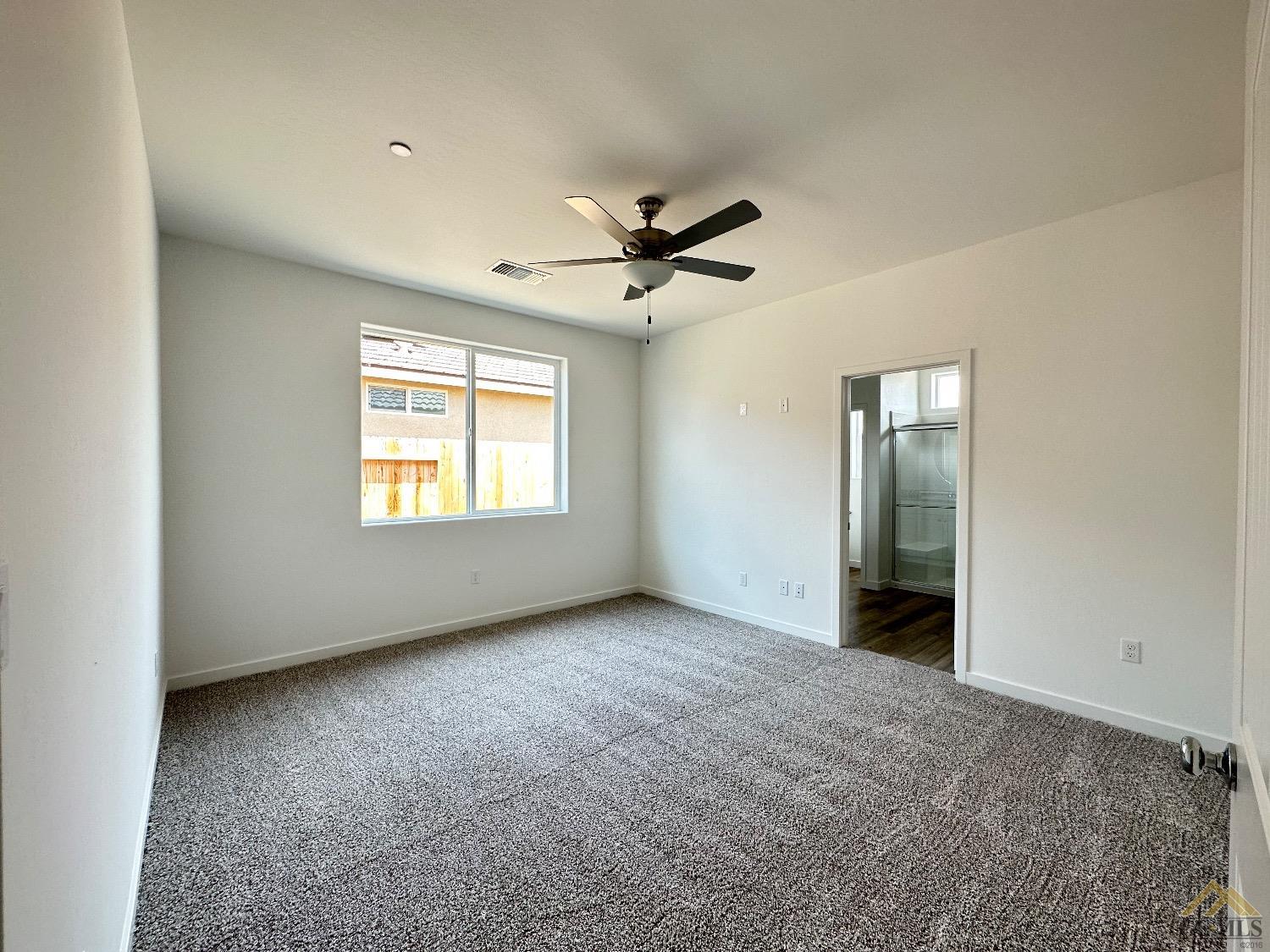 Undisclosed Address Bakersfield, CA 93311 - Photo 6 of 13 wooden floor in an empty room with a window
