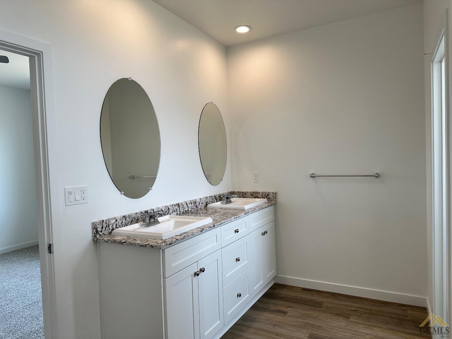 Undisclosed Address Bakersfield, CA 93311 - Photo 7 of 13 a bathroom with a double vanity sink and mirror