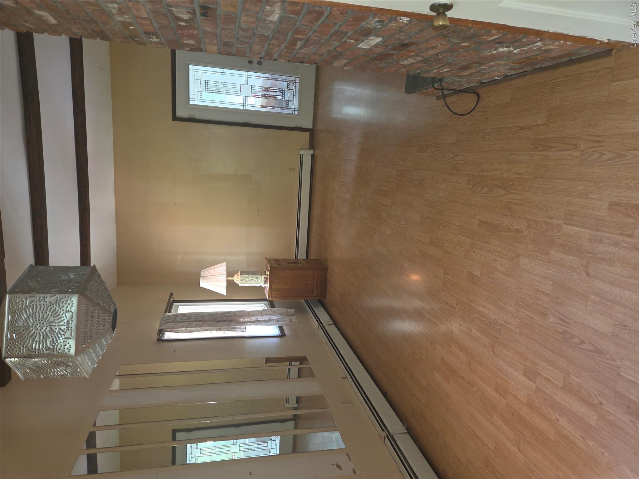 63 Otens Road Ellenville, NY 12428 - Photo 4 of 32 a view of an empty room with window and wooden floor