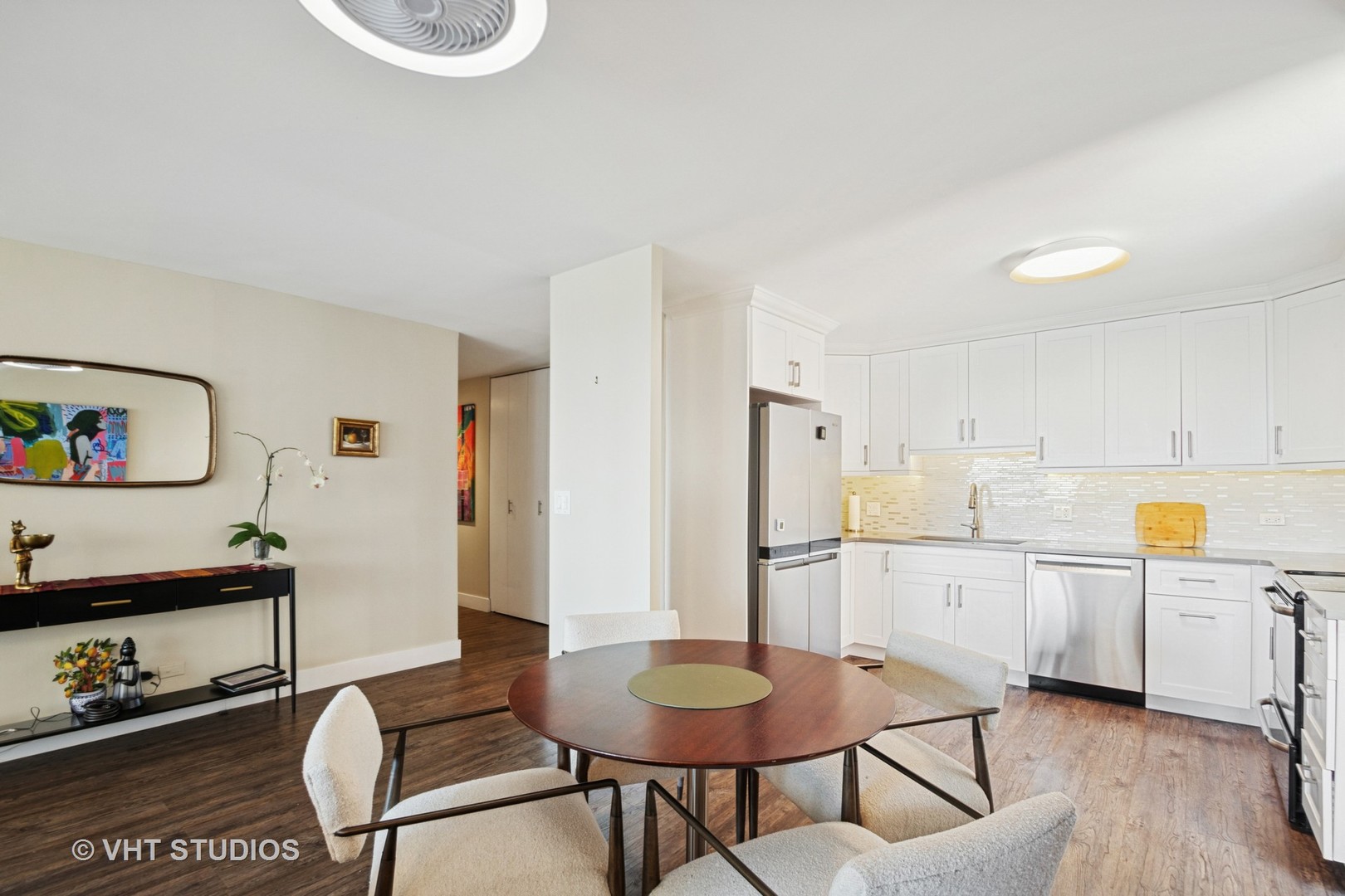 3150 North Sheridan Road, Unit 5A Chicago, IL 60657 - Photo 13 of 34 a kitchen with stainless steel appliances granite countertop a table chairs and a refrigerator