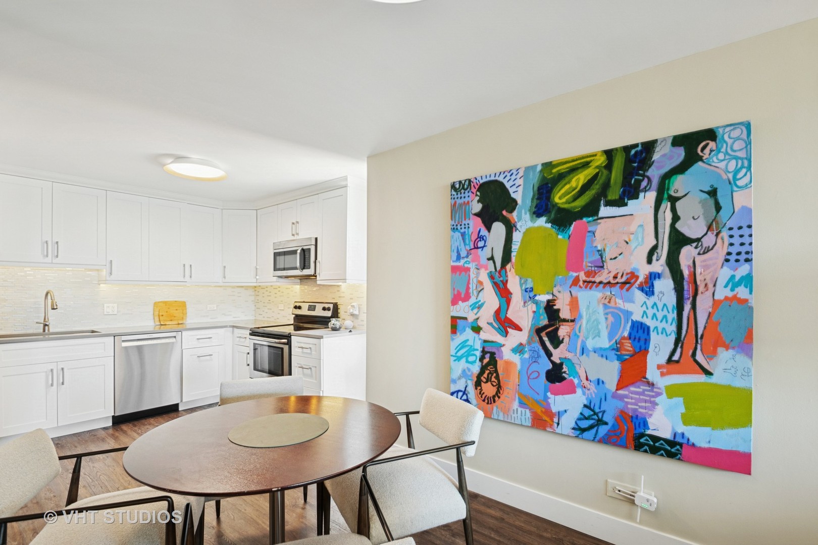 3150 North Sheridan Road, Unit 5A Chicago, IL 60657 - Photo 14 of 34 a kitchen with stainless steel appliances a dining table and chairs