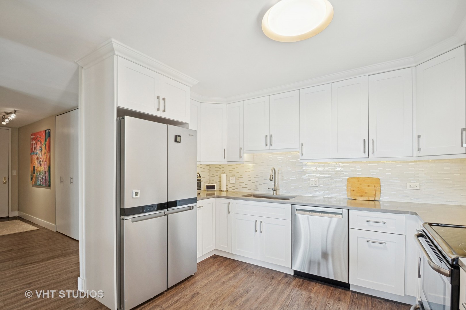 3150 North Sheridan Road, Unit 5A Chicago, IL 60657 - Photo 16 of 34 a kitchen with a refrigerator sink and cabinets