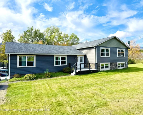 a view of a house with a swimming pool and a yard