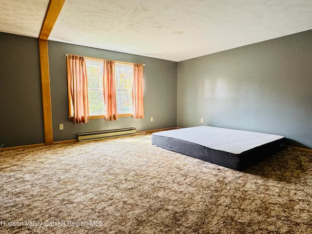 a bathroom with a granite countertop sink mirror vanity and toilet