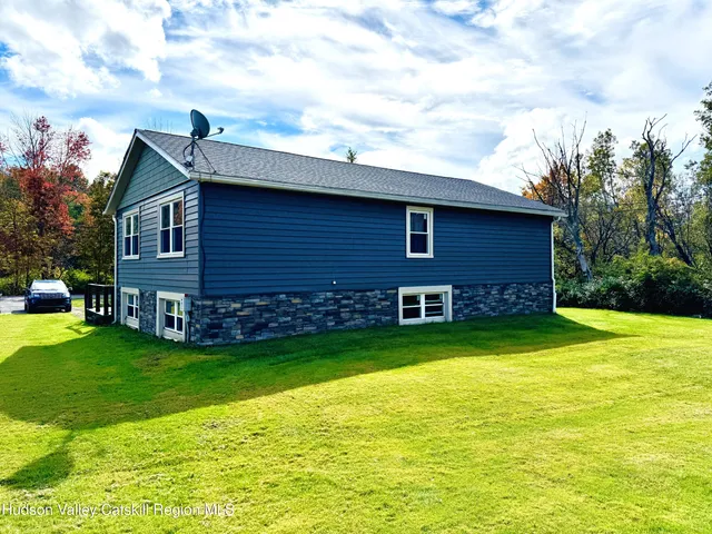 a view of a house with a backyard
