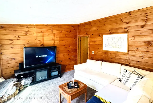a living room with a fireplace furniture and a flat screen tv