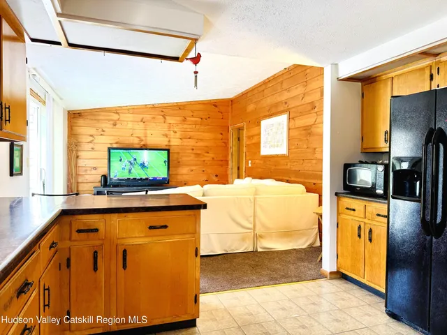 a living room with a flat screen tv and a table