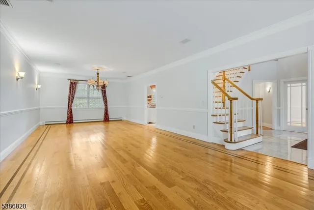 a view of empty room with wooden floor