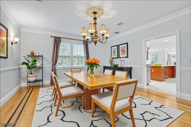 a view of a dining room with furniture and a chandelier