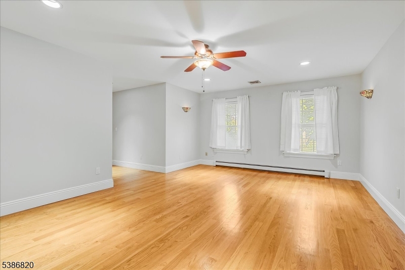 47 Stonehedge Drive Stockholm, NJ 07460 - Photo 17 of 36 a view of an empty room with window and wooden floor