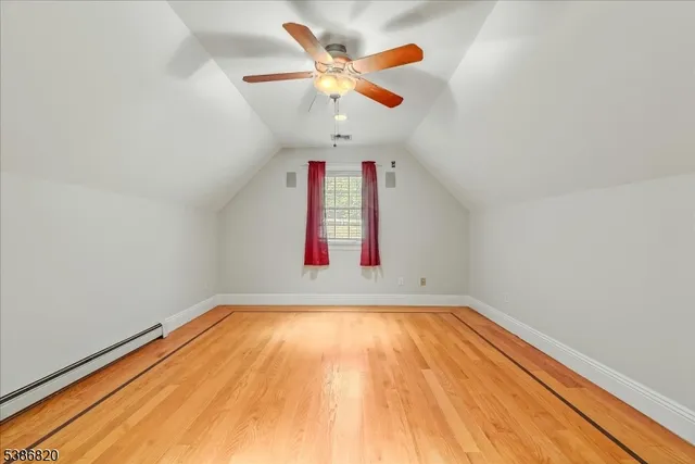 a view of a room with window and ceiling fan