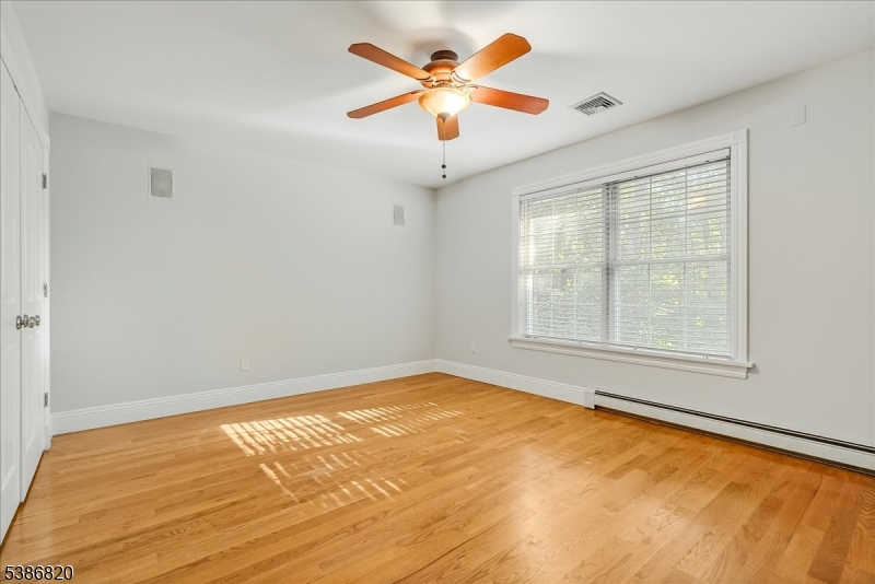 47 Stonehedge Drive Stockholm, NJ 07460 - Photo 24 of 36 a view of an empty room with window and a chandelier fan