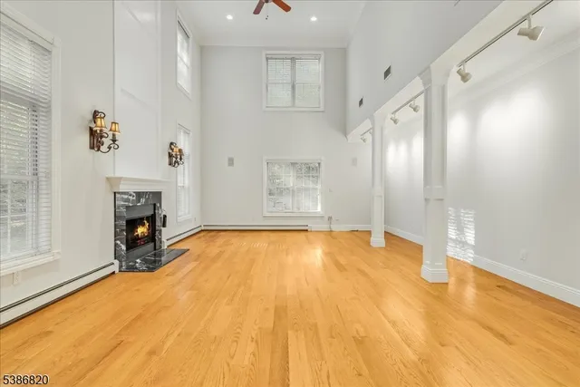 a view of empty room with fireplace and windows