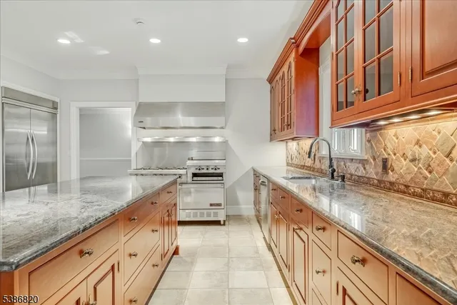 a large kitchen with granite countertop a sink and dishwasher stove top oven