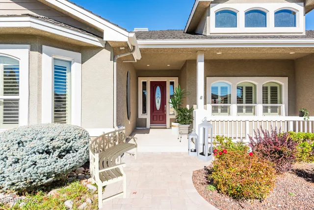an aerial view of a house with swimming pool and large trees
