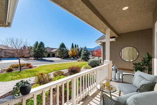 a view of a patio with couches chairs and a yard with wooden fence