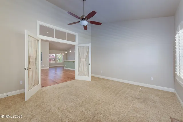 a large kitchen with stainless steel appliances kitchen island a large counter top a sink and a refrigerator