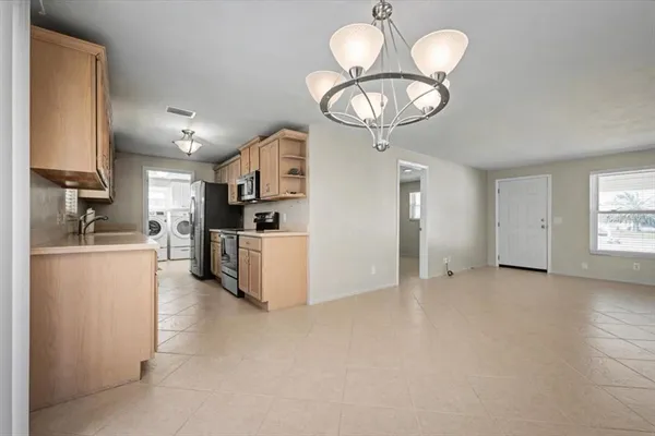 a kitchen with white cabinets a sink and dishwasher