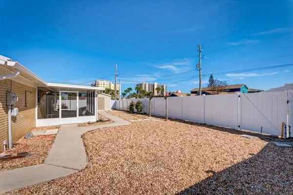 a view of a room with a wooden floor and cabinets