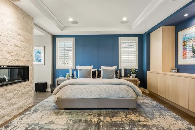 a spacious bedroom with a large bed and a wooden floor