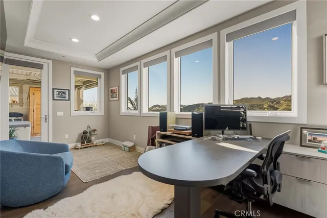 a bathroom with a granite countertop sink and mirror with bathtub