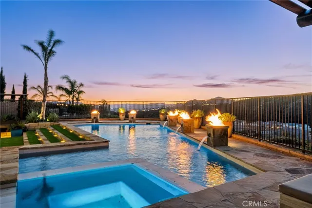 a view of a house with swimming pool and sitting area