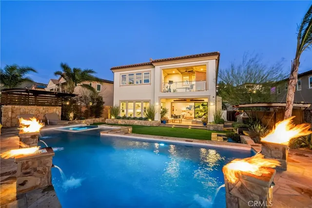 a living room with furniture floor to ceiling windows and a fireplace