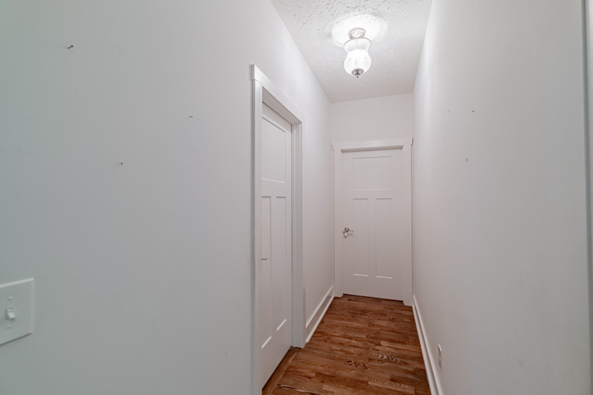 362 Lakeview Street Manchester, TN 37355 - Photo 16 of 39 a view of a hallway with wooden floor and a chandelier