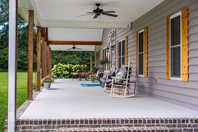 a view of a porch with chairs and backyard