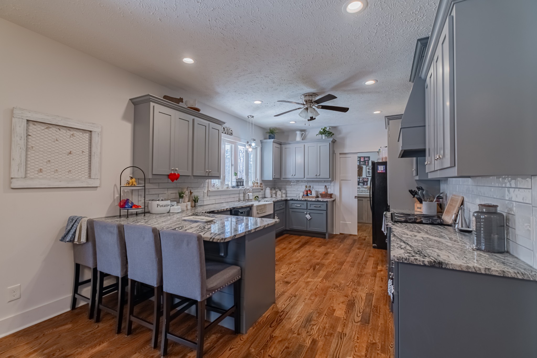 362 Lakeview Street Manchester, TN 37355 - Photo 7 of 39 a kitchen with cabinets a sink dishwasher a dining table and chairs with wooden floor