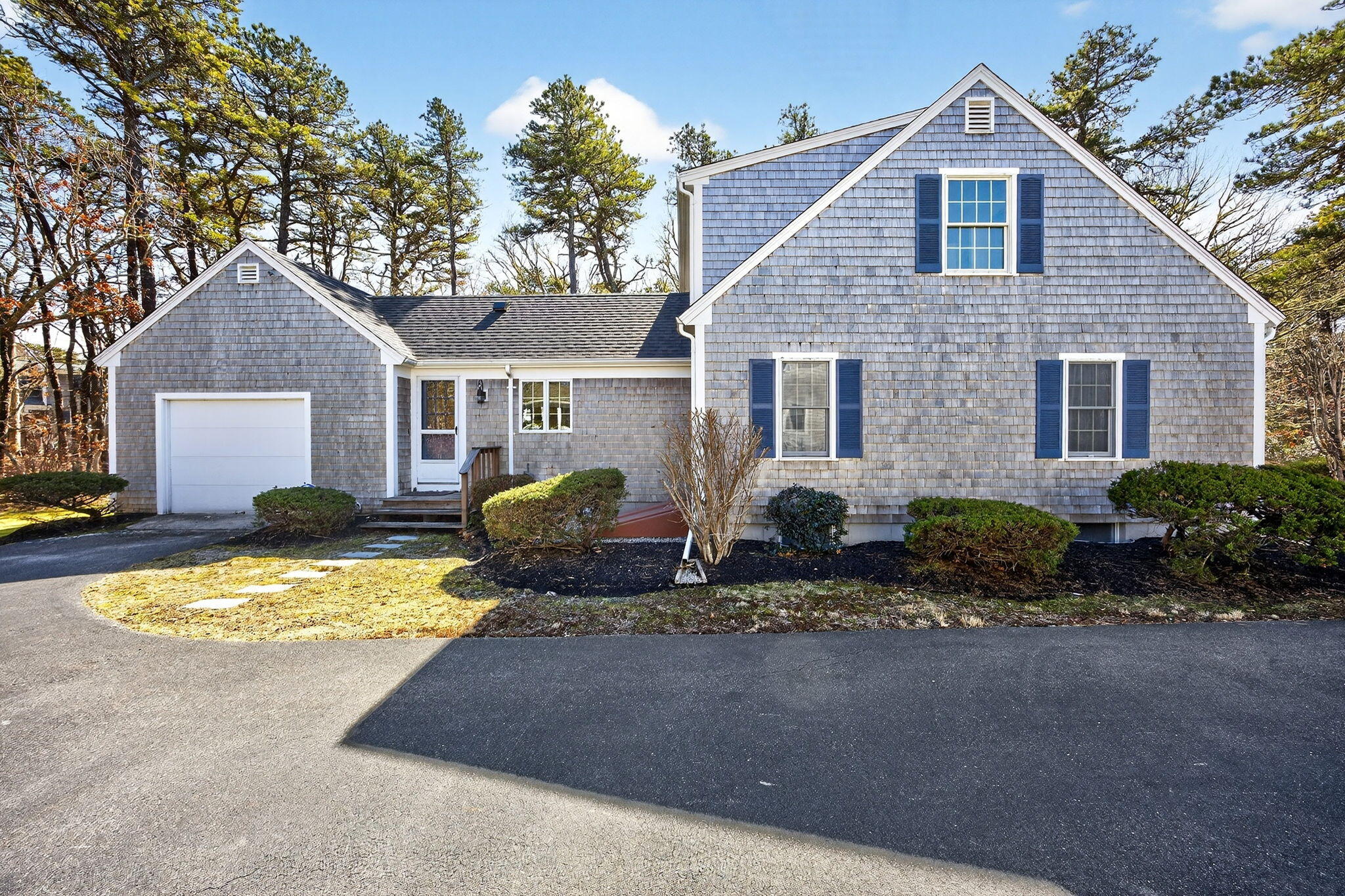 54 Marthas Lane Harwich, MA 02645 - Photo 42 of 53 a front view of a house with a yard and garage