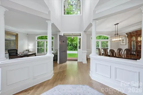 a large living room with stainless steel appliances granite countertop furniture a large window a rug and a window