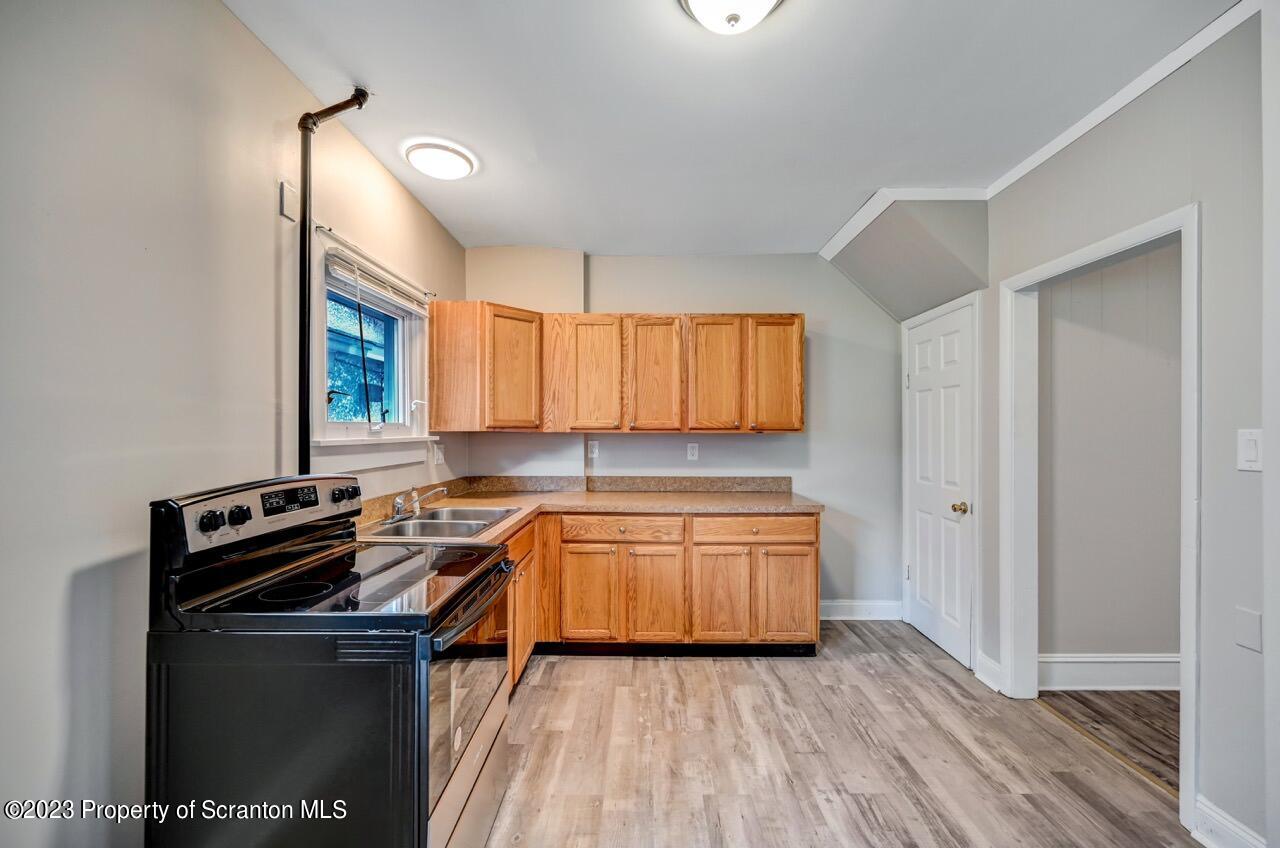 915 Ridge Avenue Scranton, PA 18510 - Photo 11 of 39 a kitchen with stainless steel appliances a sink stove and cabinets