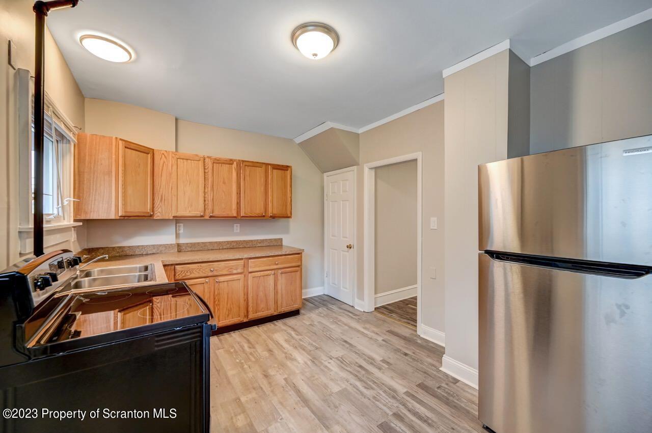 915 Ridge Avenue Scranton, PA 18510 - Photo 12 of 39 a kitchen with a refrigerator sink and cabinets