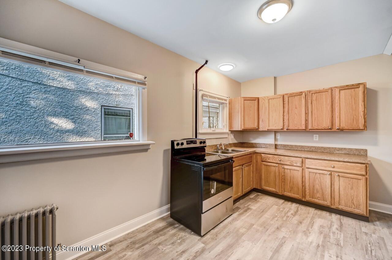 915 Ridge Avenue Scranton, PA 18510 - Photo 13 of 39 a kitchen with stainless steel appliances granite countertop a stove and a sink