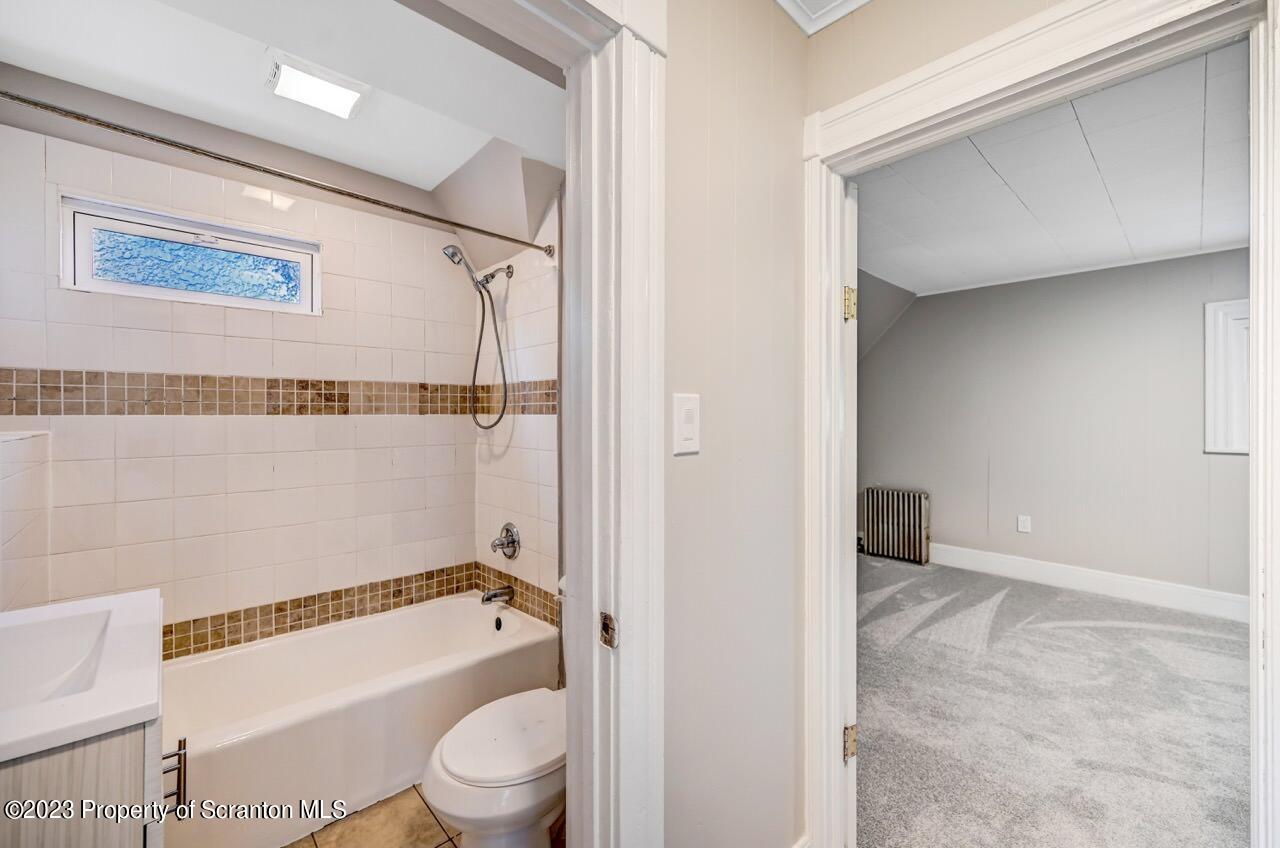 915 Ridge Avenue Scranton, PA 18510 - Photo 21 of 39 a bathroom with a granite countertop bathtub shower and toilet