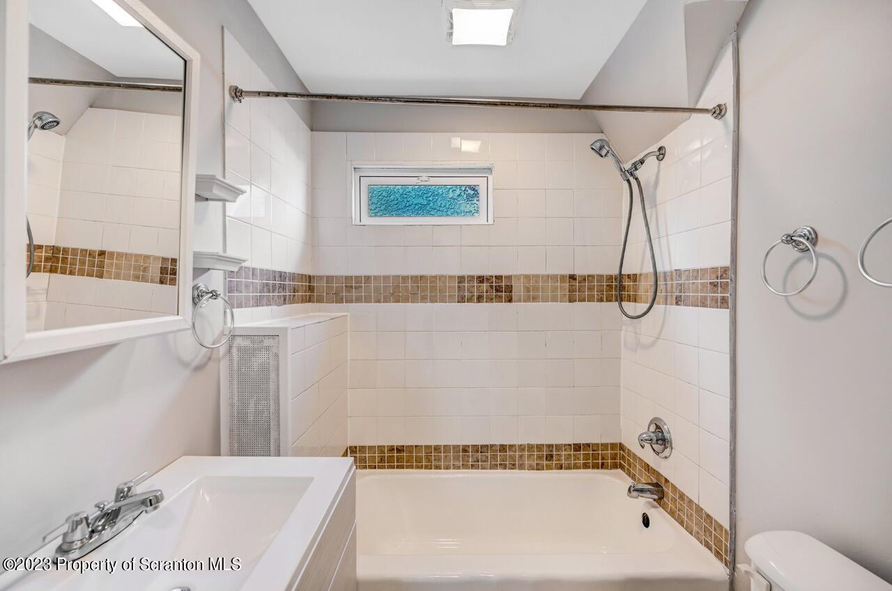 915 Ridge Avenue Scranton, PA 18510 - Photo 22 of 39 a bathroom with a bathtub and a shower