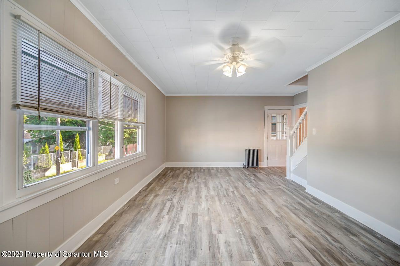 915 Ridge Avenue Scranton, PA 18510 - Photo 5 of 39 a view of an empty room with wooden floor and a window
