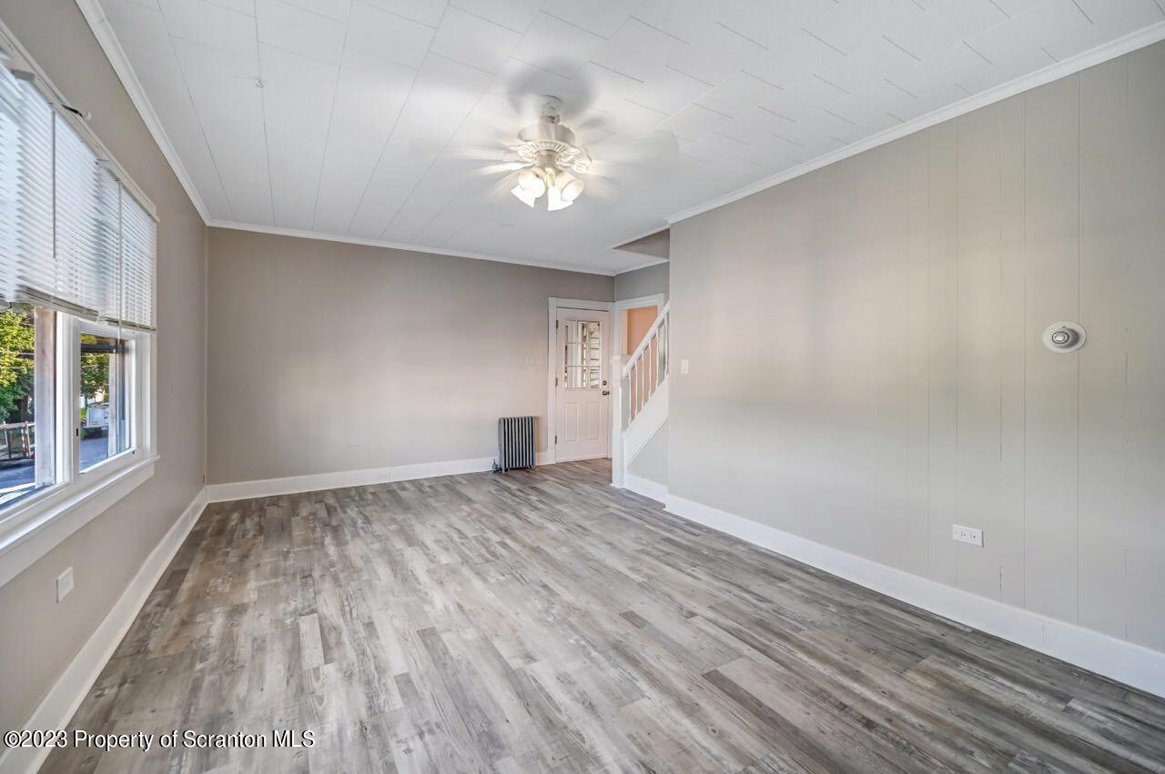 915 Ridge Avenue Scranton, PA 18510 - Photo 6 of 39 a view of an empty room with wooden floor and a window